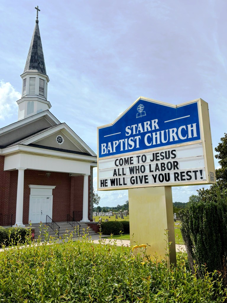 Starr Baptist Church building with roadside sign and marquee welcoming visitors